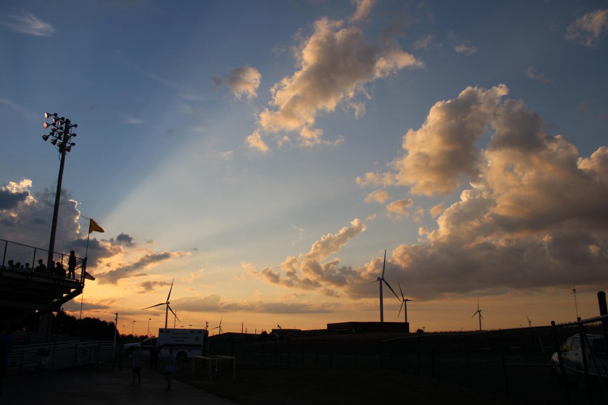 The sun sets at the 9/20 football game.