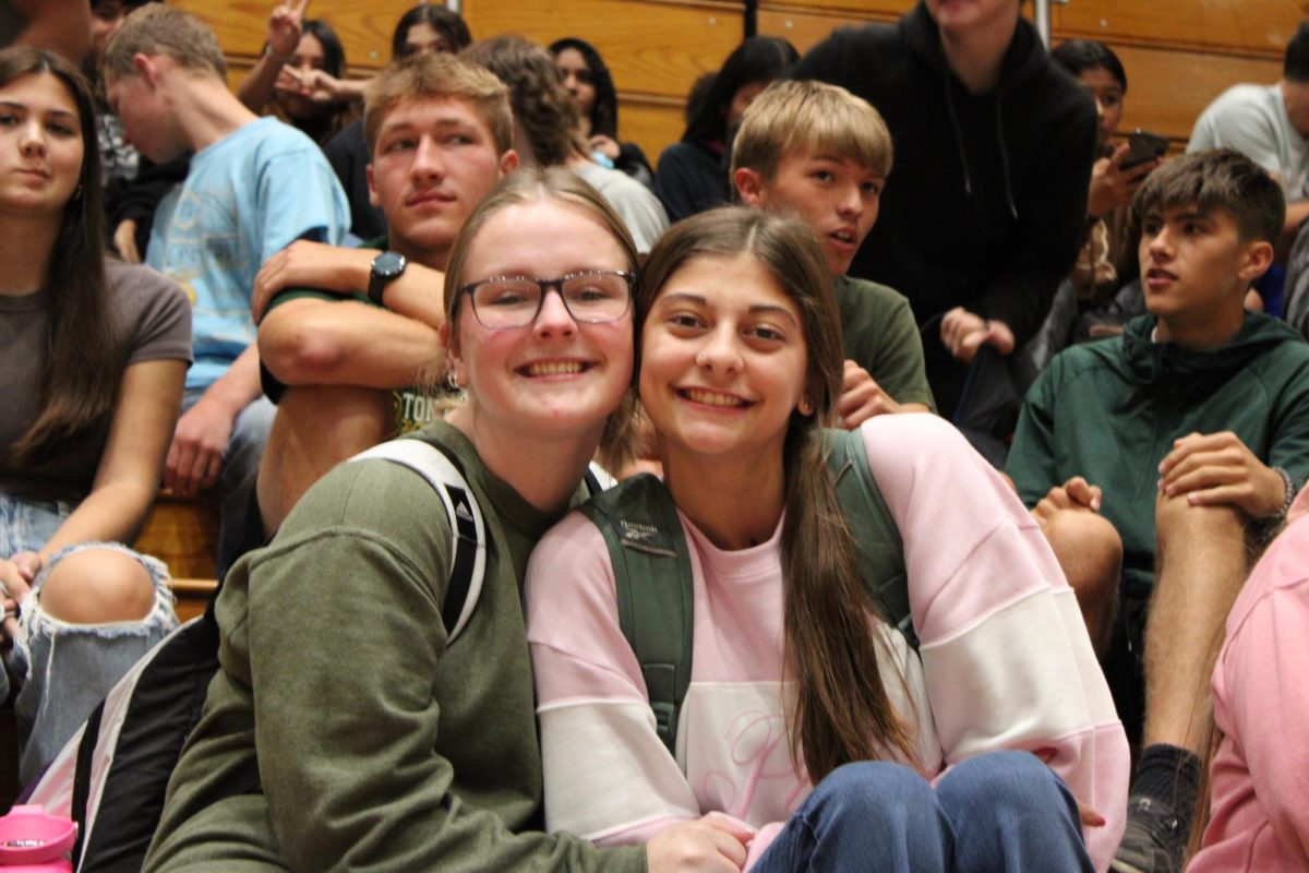 Two friends pose for the camera.