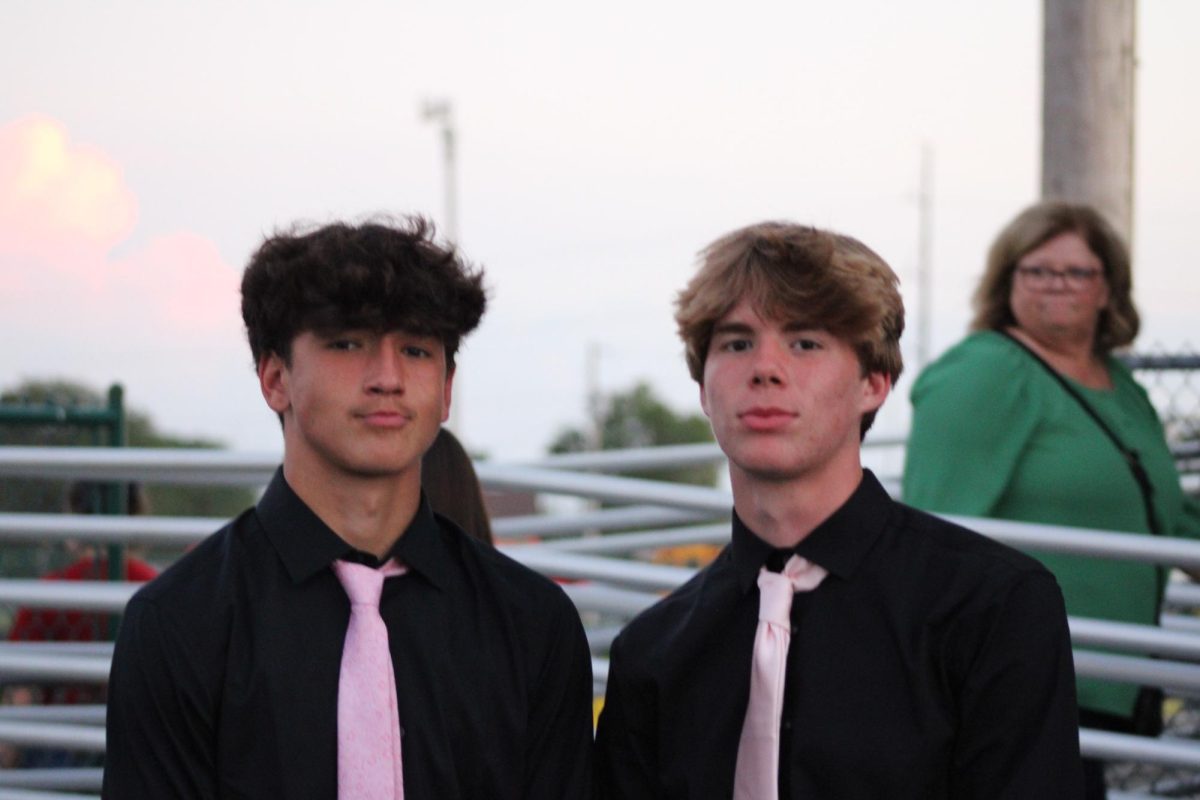 Zed Bennett and Brennan Lukaszka pose before halftime court crownings. 