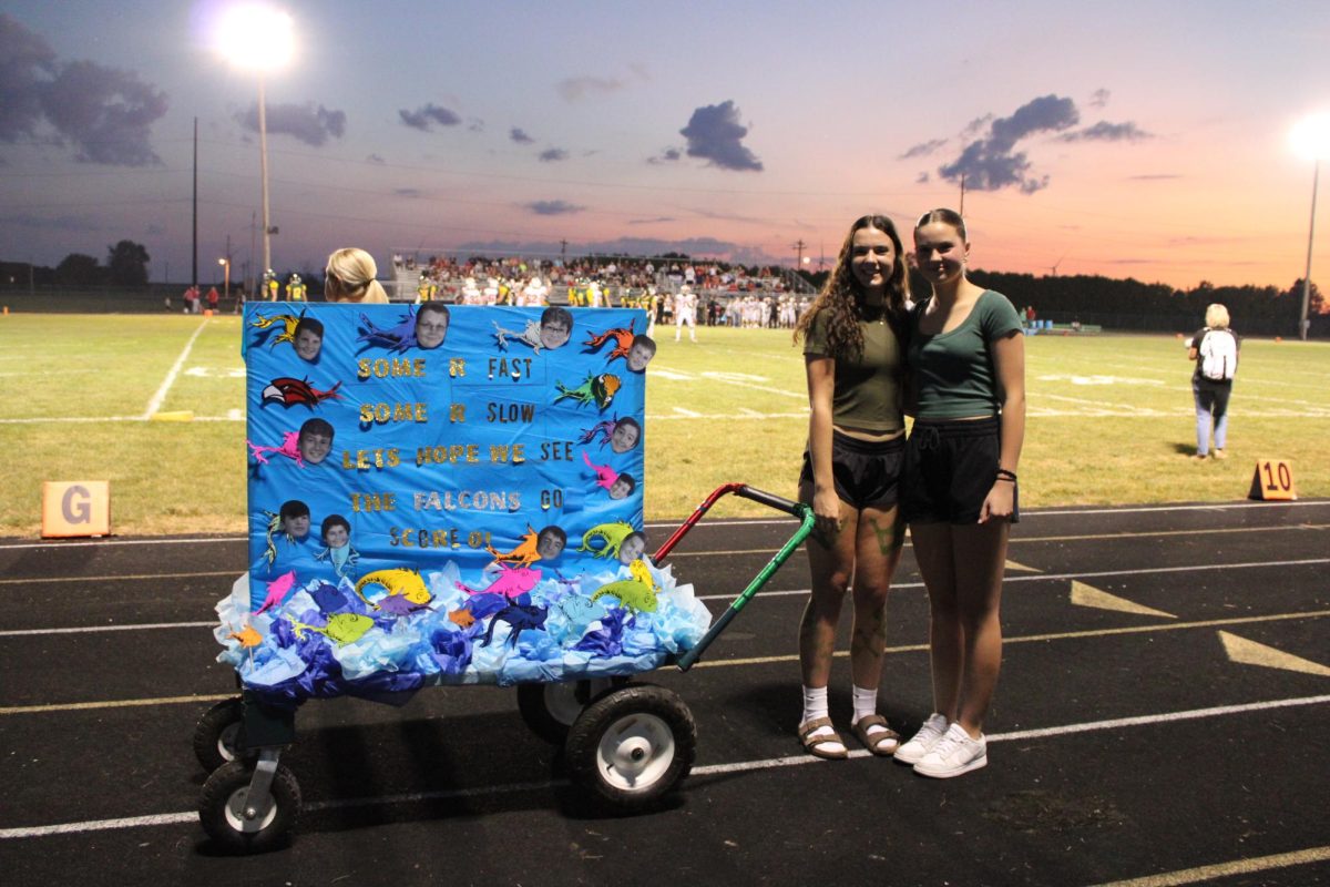 Freshmen Leah Strasburger and Hannah Wetli pose with their "Red Fish, Blue Fish, One Fish, Two Fish" themed class cart. 