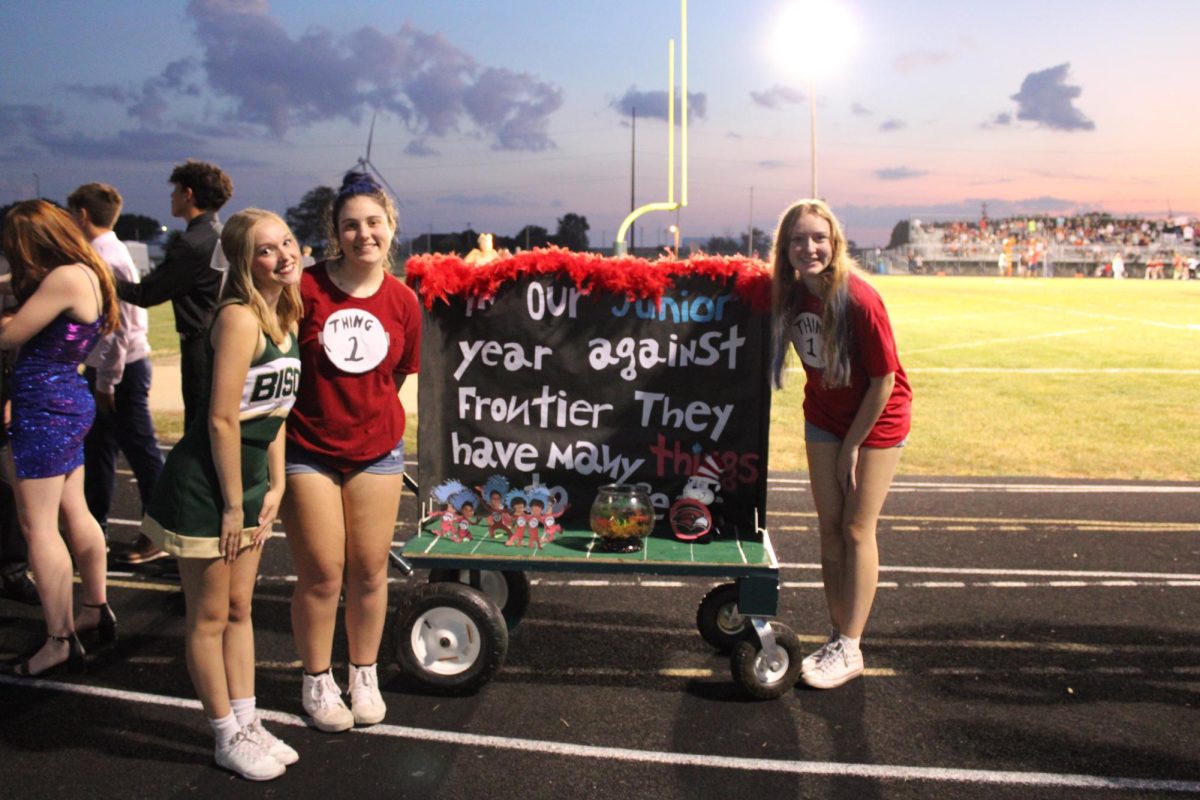 Juniors Anna Hagen, Emily Caldanaro, and Kyra Jaworski-Kraud pose with their "Cat-in-the-Hat" themed class cart. 