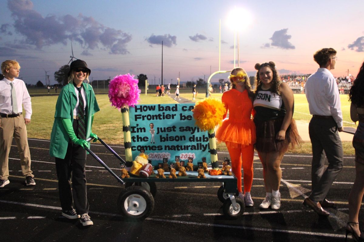 Seniors Reece Kerkhoff, Savannah Wirtz, and Emily Rodriguez pose with their 
"Lorax" themed class cart. 