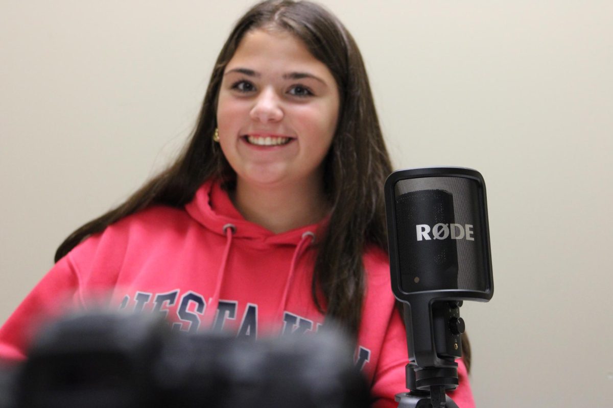 Keely Watt posing for a photo in the Broadcast/Media Room