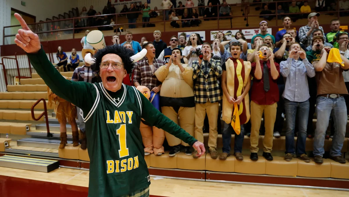 Dick Atha leads the Bison fans in his famous 