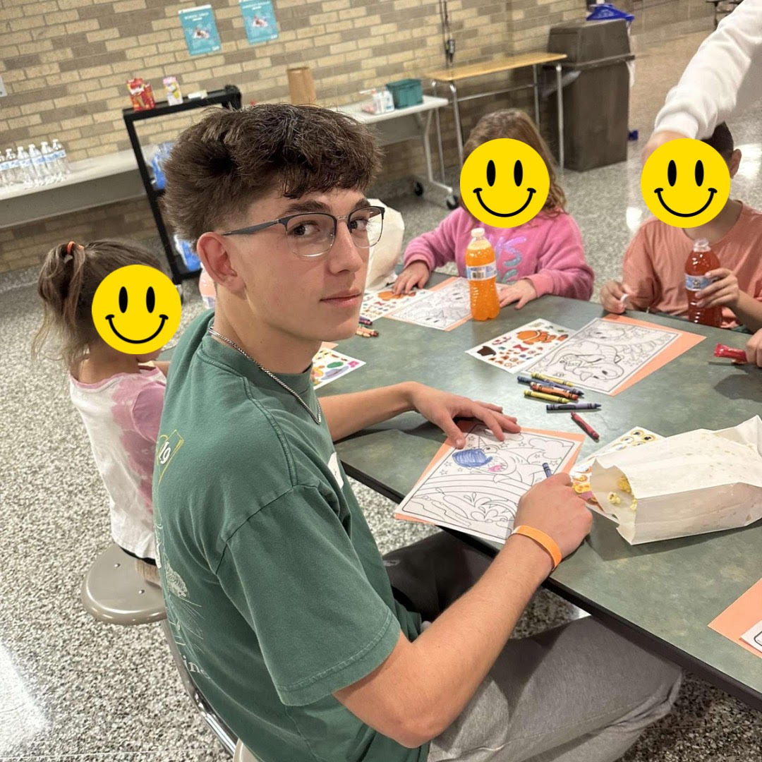 A BPA Member helping and coloring with the kids in their group 