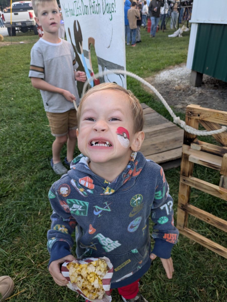 A child with their face painted by the BC Spanish Club at the Dan Patch Rodeo. 